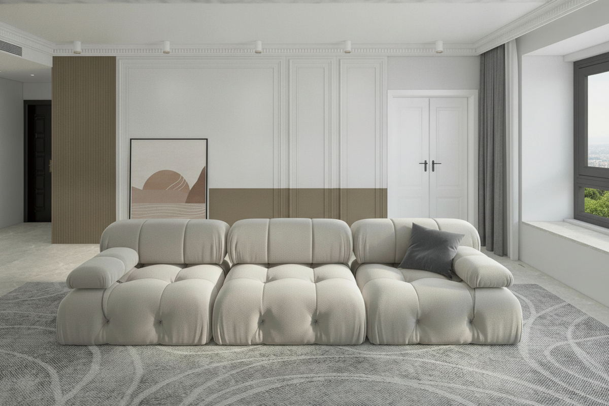 A luxurious charcoal velvet modular sectional sofa in a bright, minimalist living room with a slate gray accent pillow.